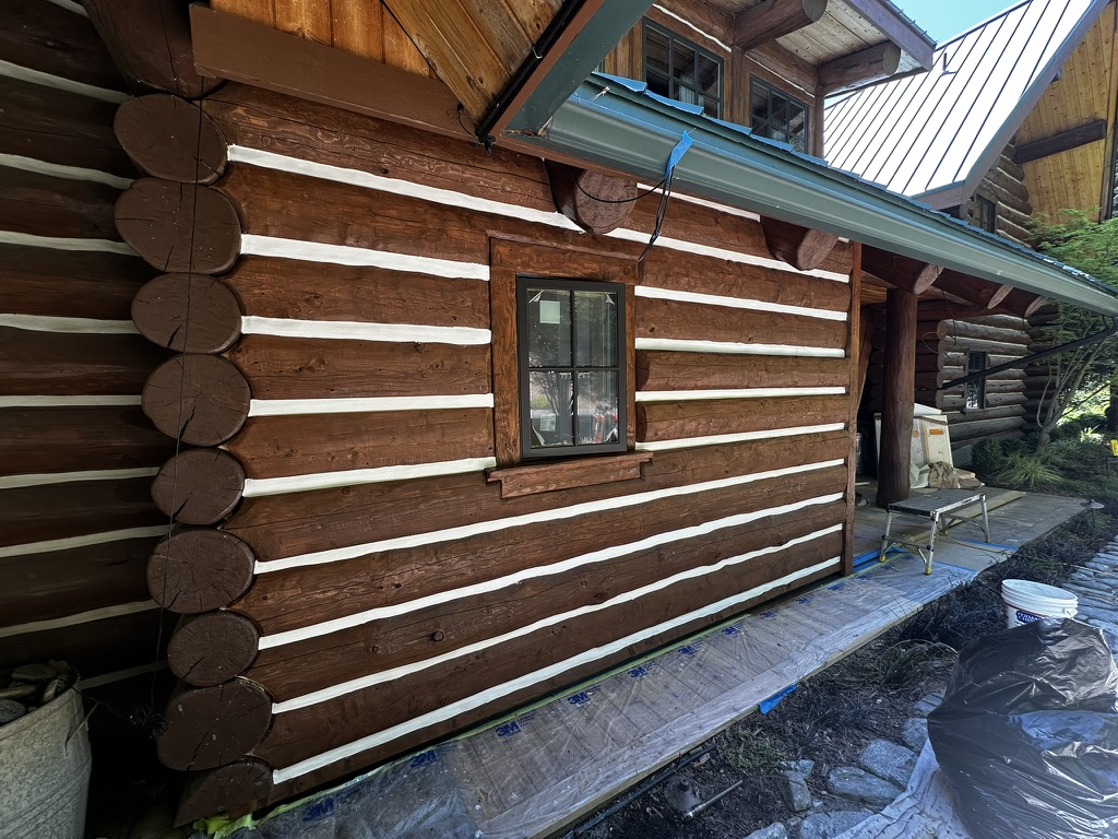 Completed log home exterior with fresh chinking and stain