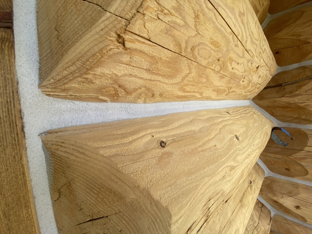 Close-up of log corner joint with fresh chinking