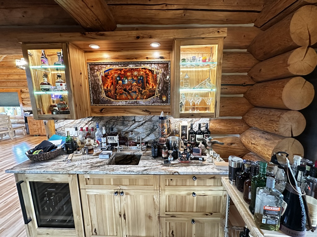 Finished log home interior with custom bar and stained walls