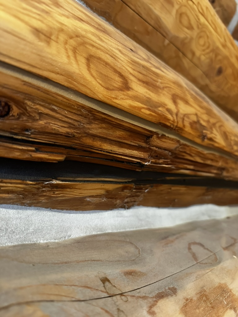 Close-up of log rot and checking between log courses