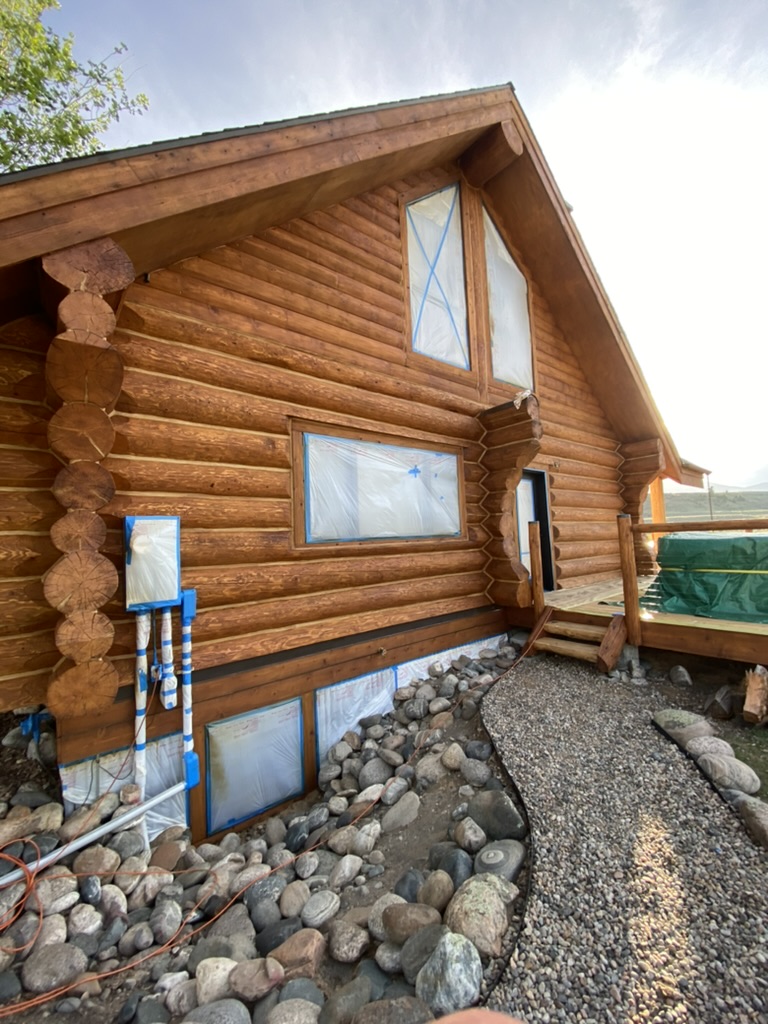 Log home exterior with fresh stain application